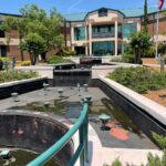The Frank C. Amerson, Jr. Water Treatment Plant building viewed across a multi-tiered concrete fountain.